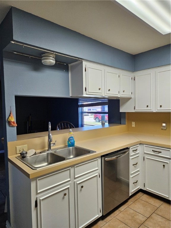 kitchen featuring dishwasher, white cabinets, sink, and light tile patterned flooring