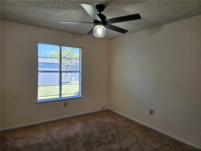 carpeted empty room featuring ceiling fan and a textured ceiling