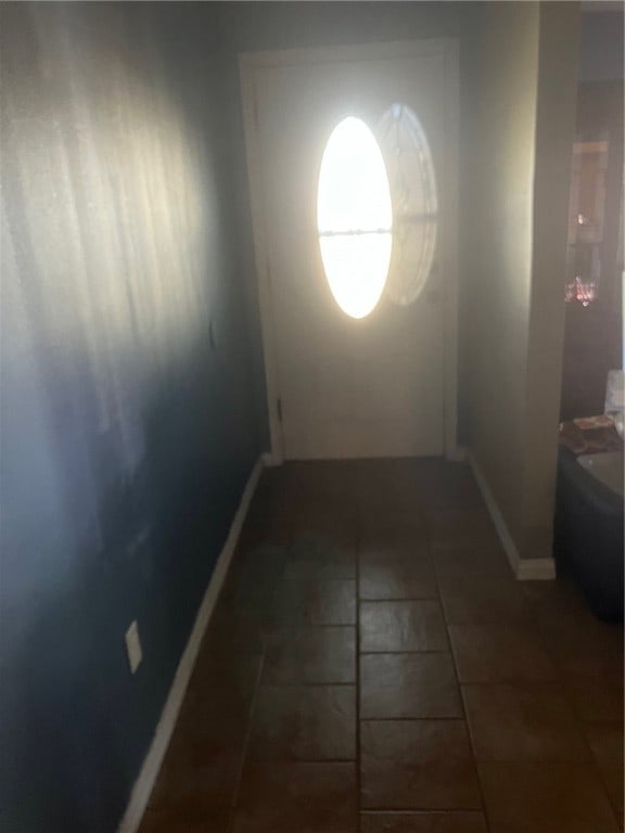 hall with dark tile patterned floors