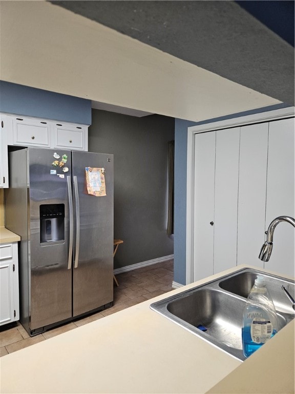 kitchen featuring white cabinetry, stainless steel refrigerator with ice dispenser, sink, and light hardwood / wood-style flooring