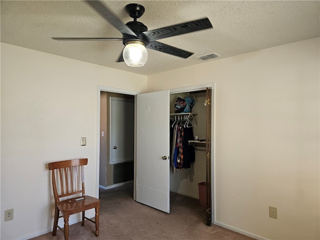 interior space featuring ceiling fan, a textured ceiling, and a closet