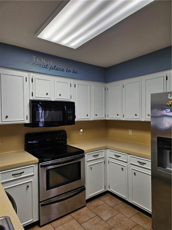 kitchen with white cabinetry, appliances with stainless steel finishes, and light tile patterned floors