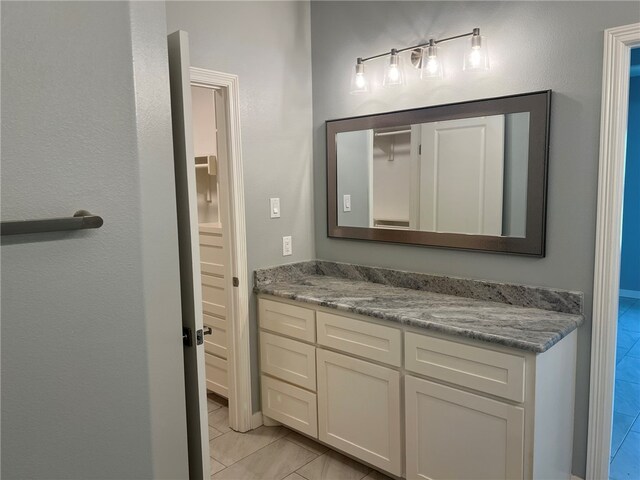 bathroom featuring tile patterned flooring and vanity