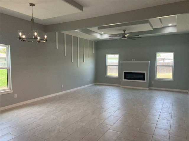 unfurnished living room with ceiling fan with notable chandelier and light tile patterned flooring