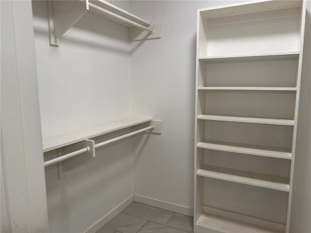 spacious closet with light tile patterned floors