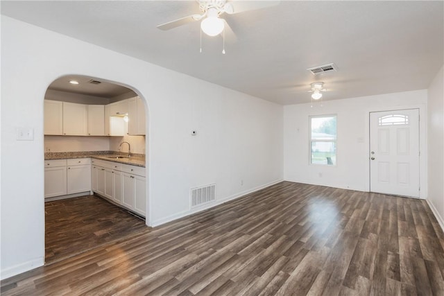 4845 Johnston Dr, Corpus Christi, TX 78415 - unfurnished living room featuring a ceiling fan, a sink, dark wood-style flooring, and baseboards
