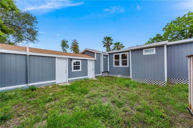 4845 Johnston Dr, Corpus Christi, TX 78415 - rear view of house featuring an outbuilding and a yard