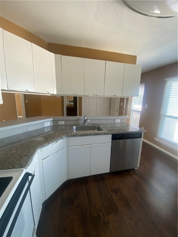 kitchen featuring white cabinets, sink, stainless steel dishwasher, dark hardwood / wood-style floors, and kitchen peninsula