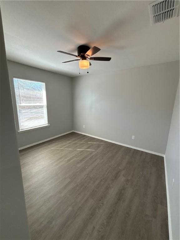 110 Josephine St, Corpus Christi, TX 78401 - spare room with a ceiling fan, dark wood-style flooring, and baseboards