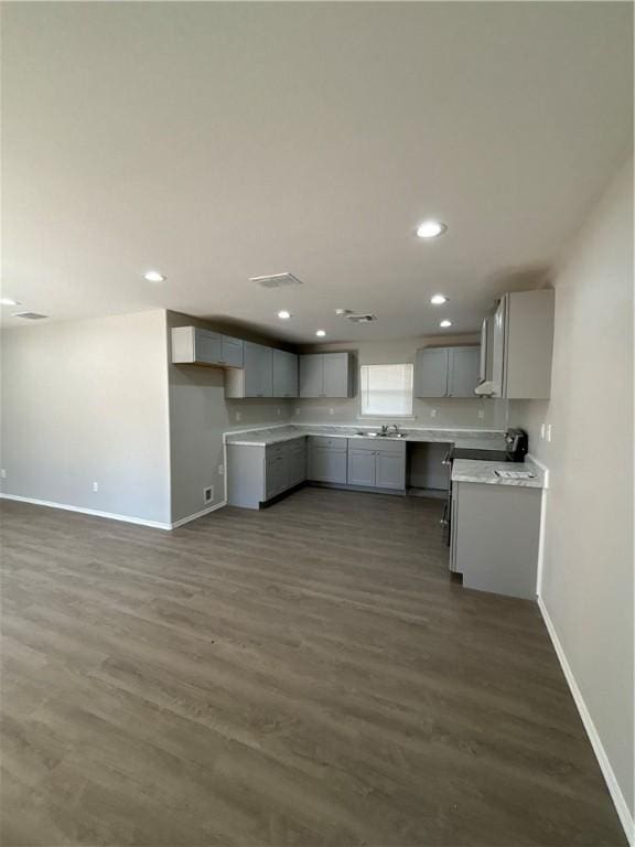 110 Josephine St, Corpus Christi, TX 78401 - kitchen featuring gray cabinets, baseboards, recessed lighting, dark wood-style flooring, and light countertops