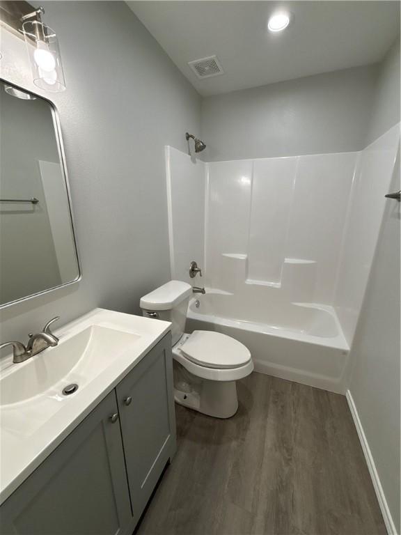 110 Josephine St, Corpus Christi, TX 78401 - full bathroom with wood finished floors, toilet, bathtub / shower combination, and vanity