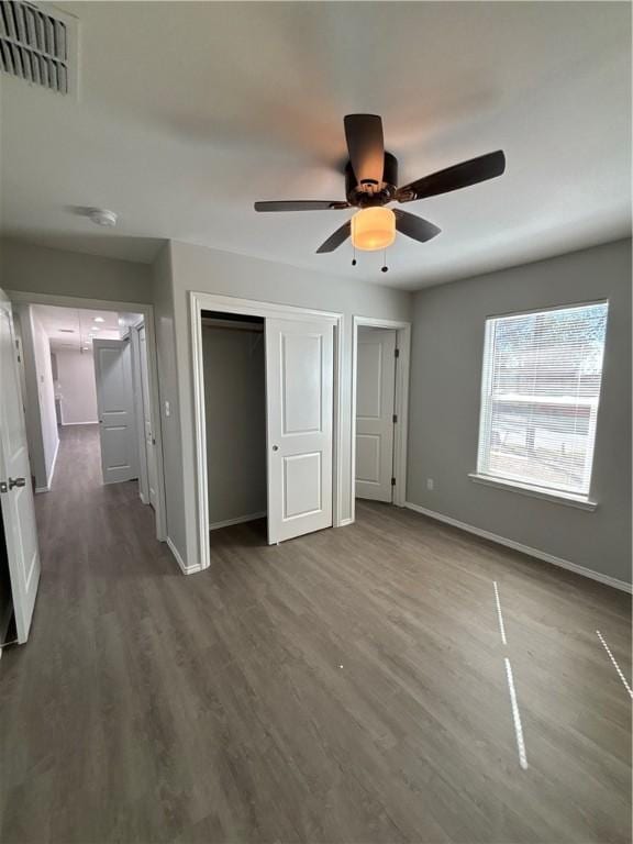 110 Josephine St, Corpus Christi, TX 78401 - unfurnished bedroom with baseboards, wood finished floors, ceiling fan, a closet, and attic access