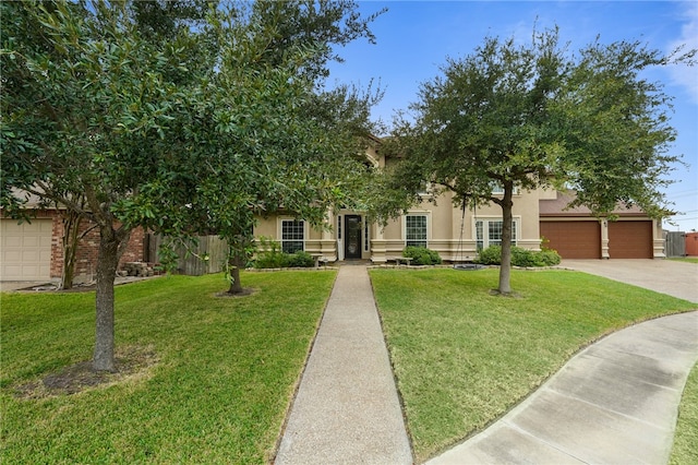 obstructed view of property featuring a garage and a front yard