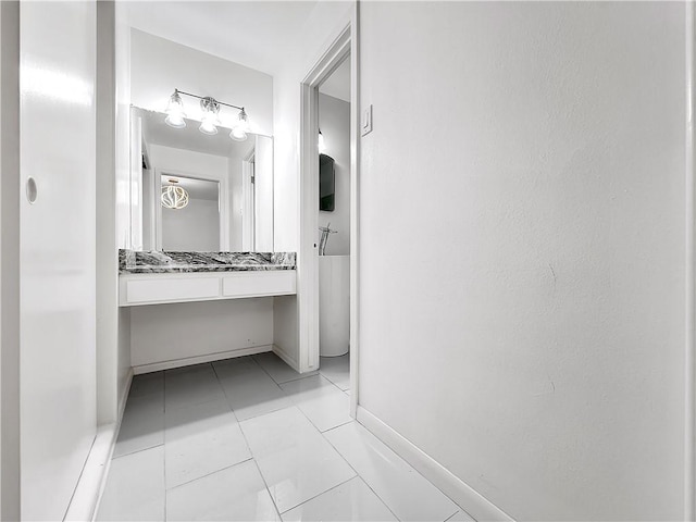 bathroom featuring baseboards and vanity
