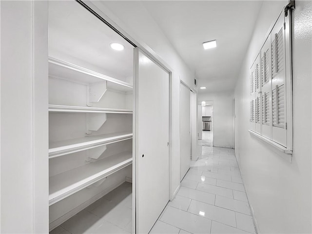 hallway featuring marble finish floor and recessed lighting