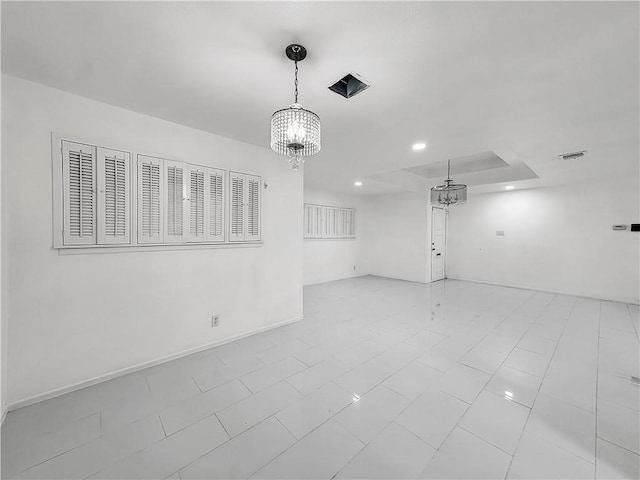 spare room featuring recessed lighting, visible vents, baseboards, and an inviting chandelier