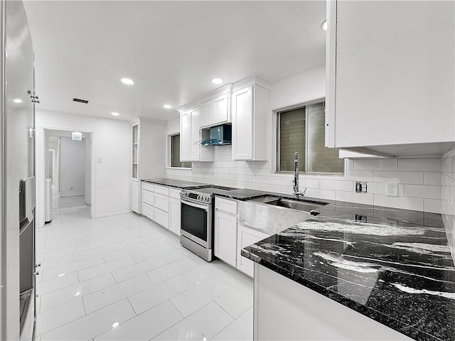 kitchen featuring a sink, stainless steel electric range, recessed lighting, decorative backsplash, and wall chimney range hood