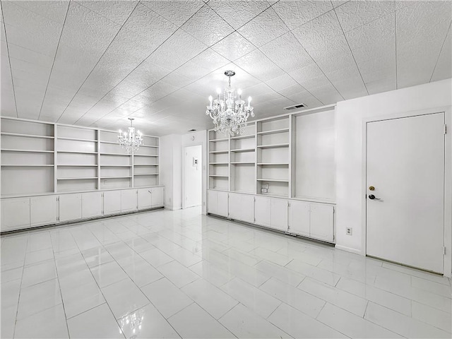 interior space featuring visible vents, built in features, and a notable chandelier