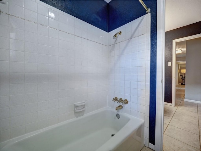 bathroom featuring tile patterned floors and tiled shower / bath combo