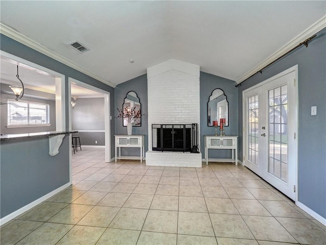 unfurnished living room with french doors, ornamental molding, light tile patterned floors, a fireplace, and lofted ceiling