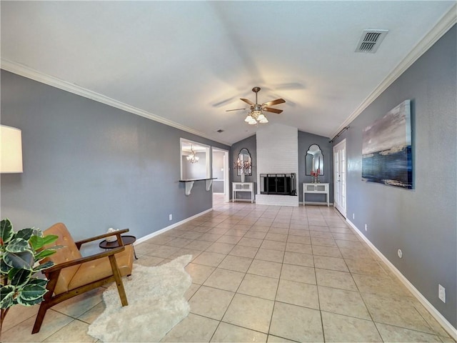 living room featuring vaulted ceiling, a fireplace, light tile patterned flooring, ceiling fan with notable chandelier, and ornamental molding