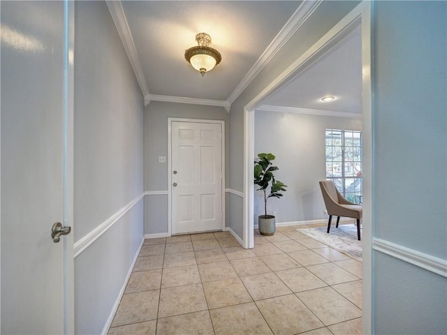 tiled foyer featuring ornamental molding