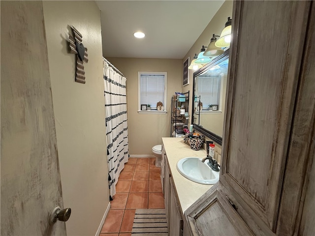 bathroom featuring tile patterned flooring, vanity, and toilet