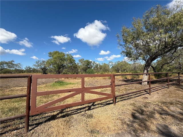 view of gate with a rural view