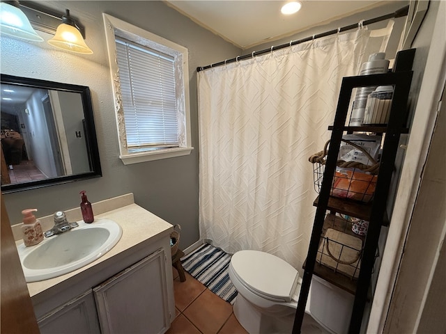 bathroom with tile patterned floors, vanity, and toilet