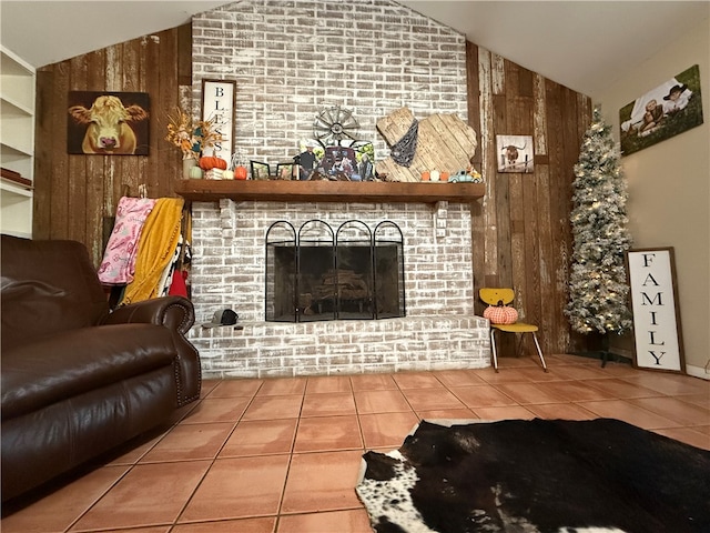 tiled living room featuring wood walls, a fireplace, and vaulted ceiling