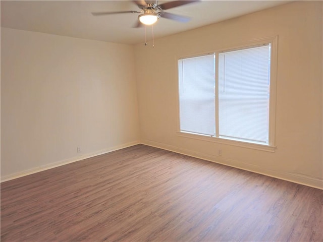 unfurnished room with ceiling fan and wood-type flooring