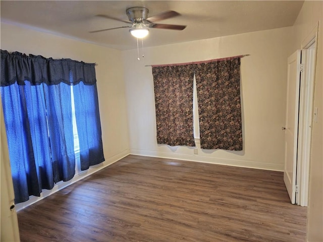 empty room featuring ceiling fan and dark wood-type flooring