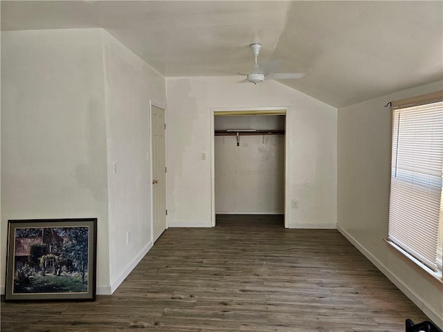 unfurnished bedroom with ceiling fan, vaulted ceiling, dark hardwood / wood-style flooring, and a closet