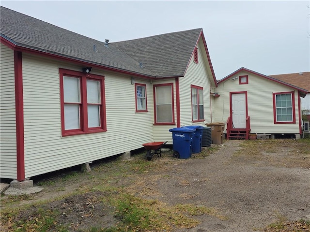 back of house featuring central air condition unit