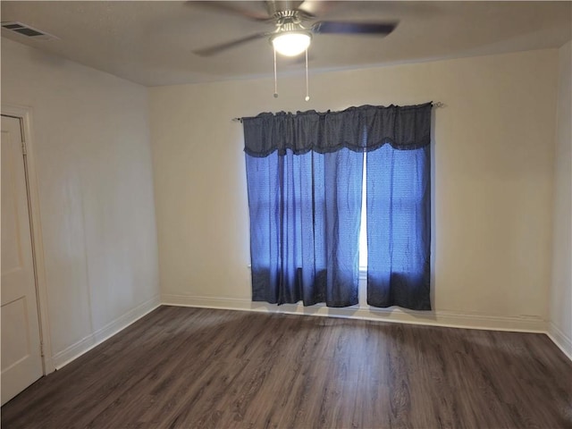 spare room with ceiling fan and dark wood-type flooring