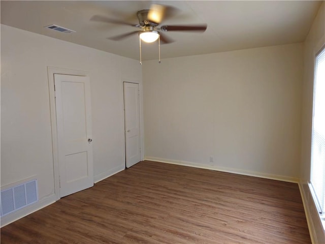 unfurnished bedroom with dark wood-type flooring and ceiling fan