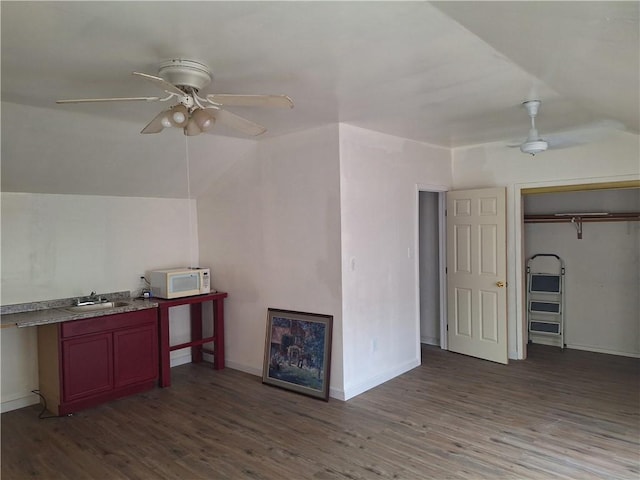 bonus room with ceiling fan, sink, and wood-type flooring