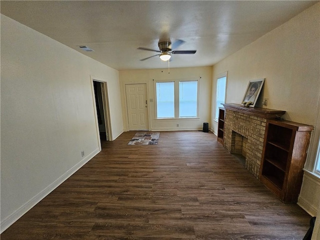 unfurnished living room featuring ceiling fan, a fireplace, and dark hardwood / wood-style floors