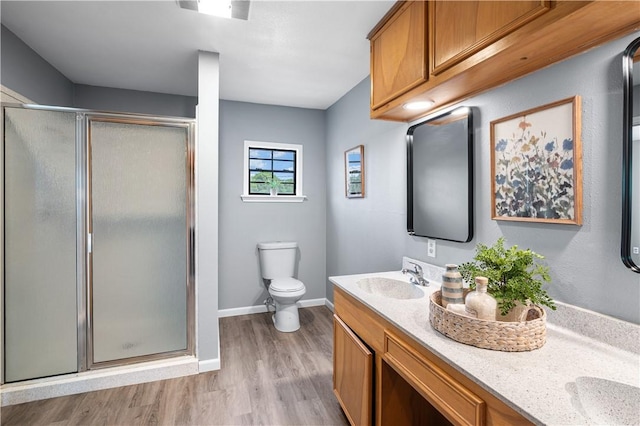 10946 Birdwood, Corpus Christi, TX 78410 - bathroom with a shower stall, wood finished floors, double vanity, and baseboards