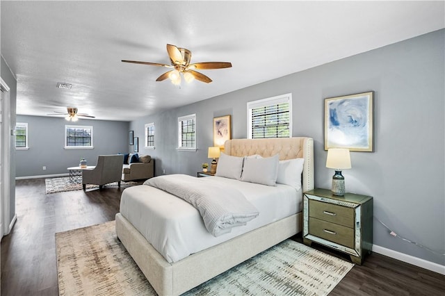 10946 Birdwood, Corpus Christi, TX 78410 - bedroom featuring multiple windows, dark wood-type flooring, and baseboards