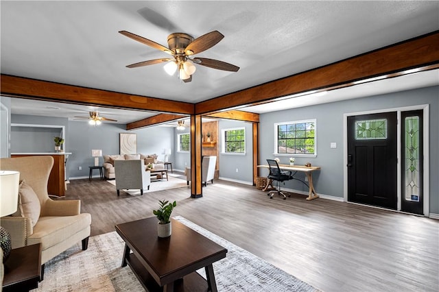 10946 Birdwood, Corpus Christi, TX 78410 - living area with ceiling fan, wood finished floors, beamed ceiling, baseboards, and a desk