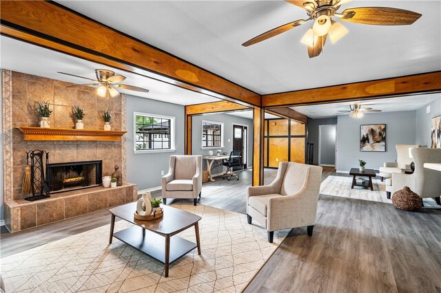 10946 Birdwood, Corpus Christi, TX 78410 - living area featuring wood finished floors, ceiling fan, baseboards, beam ceiling, and a tiled fireplace