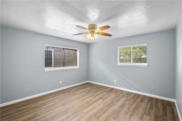 10946 Birdwood, Corpus Christi, TX 78410 - unfurnished room with wood finished floors, a textured ceiling, a ceiling fan, and baseboards
