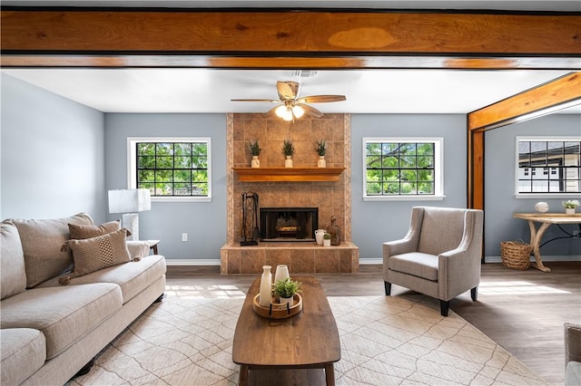 10946 Birdwood, Corpus Christi, TX 78410 - living room featuring healthy amount of natural light, a ceiling fan, wood finished floors, baseboards, and beam ceiling