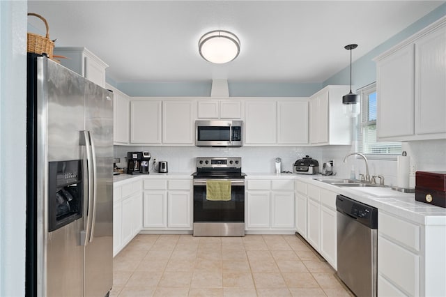 kitchen with white cabinetry, pendant lighting, and stainless steel appliances