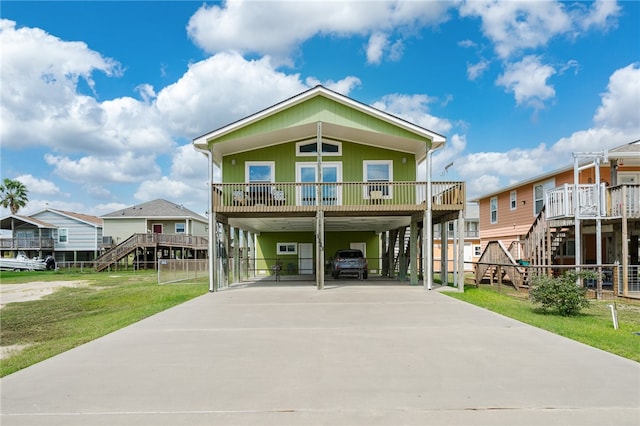 view of front of house with a front yard and a carport