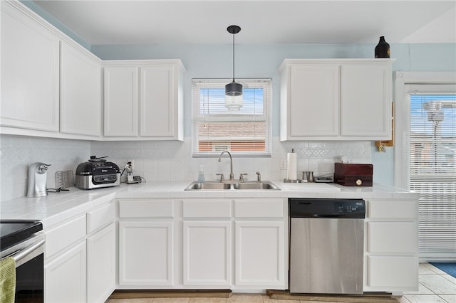 kitchen featuring pendant lighting, appliances with stainless steel finishes, sink, and white cabinets