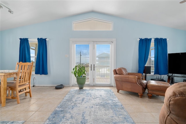 tiled living room with french doors and vaulted ceiling