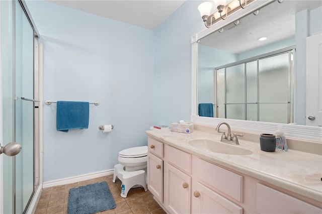 bathroom with vanity, tile patterned floors, toilet, and an enclosed shower