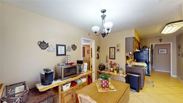 dining room featuring a notable chandelier and light tile patterned flooring